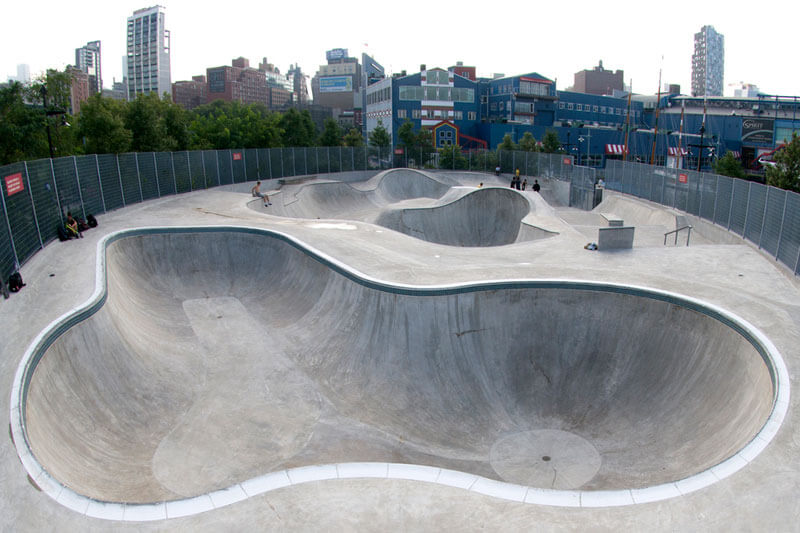 The file "chelsea_piers_62_skatepark_manhattan1.jpg" shows a large concrete skatepark with deep bowls and curved transitions, surrounded by fencing, located in an urban setting with city buildings and greenery in the background.