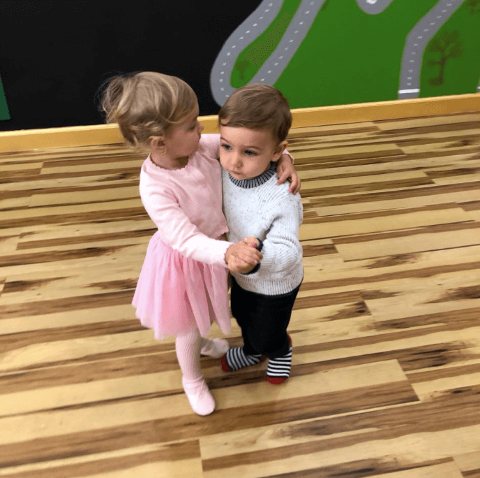 Discover
Spaces
Account
Upgrade
Install
generate alt text of 125 characters
Two young children, one in a pink dress and one in a gray sweater, hold hands and dance together on a striped wooden floor.