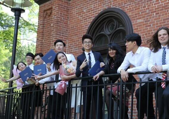students standing along a railing