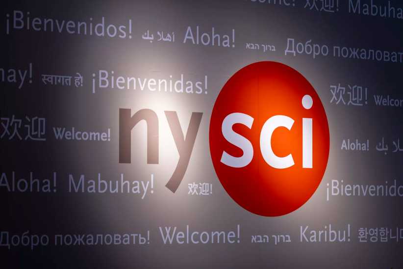 The image shows a "nysci" logo with "sci" inside a red circle and various greetings in multiple languages in the background.