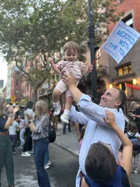 East End Temple photo man+baby with flag