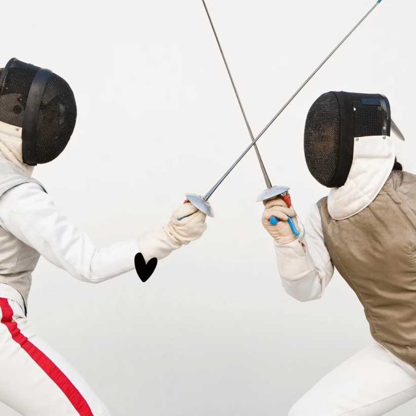 Two athletes clad in protective fencing gear and mesh masks engage in a duel, their swords crossing mid-air against a plain background.
